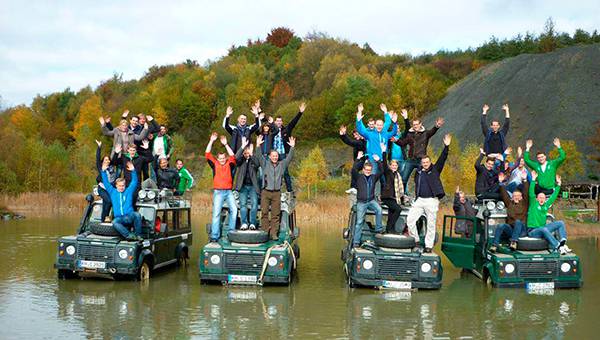 Vier Offroad-Jeeps mit vielen Menschen zum Teambuilding