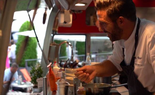 Server serving dishes out of a food truck