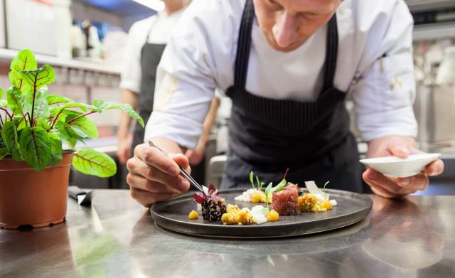 Sternekoch Maximilian Moser richtet kleinteilig ein Gericht für das Gourmetrestaurant Aubergine an