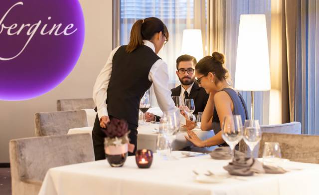 View of couple dining and being served in Gourmetrestaurant Aubergine